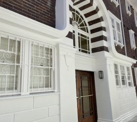 Front entrance with fresh paintwork, varnished door and restored metal bars
