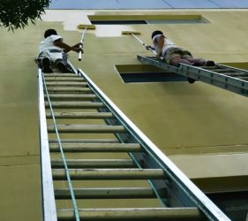 Platinum Painting crew using ladder access to repaint upper exterior walls at this St Leonards strata property