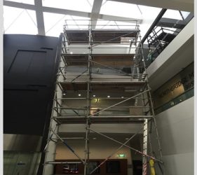 Scaffolding inside Northbridge commercial office for roof leak repair and repainting.