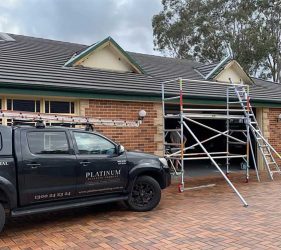 Garage Makeover – Precision painting on doors, trim, and roof.