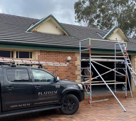 Forestville garage area before repainting, with scaffolding set up and original finish visible