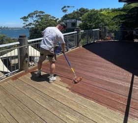 Coastal walkway deck in Mosman undergoing roller stain application.
