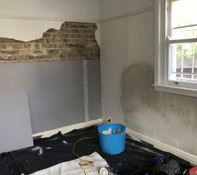 Interior renovation showing plasterboard installation and exposed brick preparation in a Crows Nest office