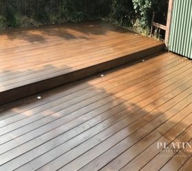 Timber deck in Sydney with stain freshly applied and drying.