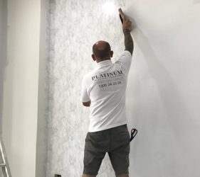 Installer positioning marble wallpaper in Bondi residence
