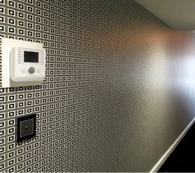 Long hallway with full black and white grid wallpaper in Vaucluse