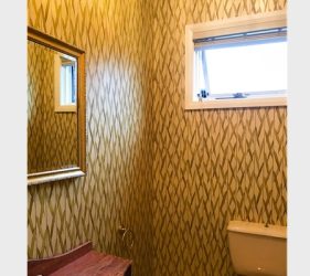 Gold geometric wallpaper completed in Paddington powder room