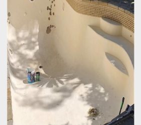Swimming pool prepared for cleaning and epoxy primer – in Sydney