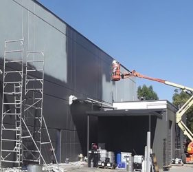 Painter using articulating boom lift at Brookvale commercial site