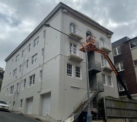 Painter on boom lift doing facade work in Kirribilli