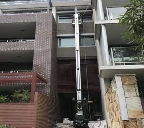 Painter using 16m electric lift at St Leonards strata project