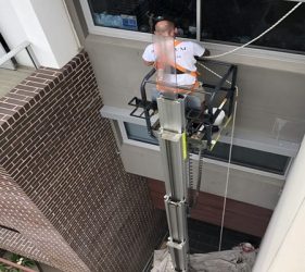 Exterior wall painting using electric lift in St Leonards