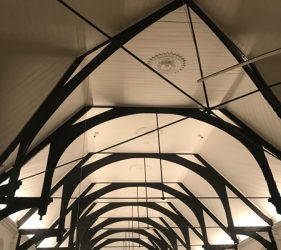 A long angle view of the bright white church ceiling with contrasting black-stained beams in Surry Hills restoration