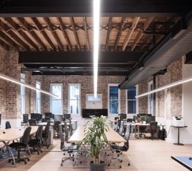 Completed Surry Hills office interior with exposed brick, matte black ducting, timber ceiling, and modern workstations