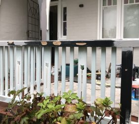 Timber rot on exterior handrail of federation home in Mosman, showing holes and deterioration
